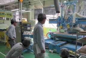 A safety officer checking safety around equipment in the factory