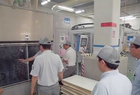 A safety officer checking safety around equipment in the factory