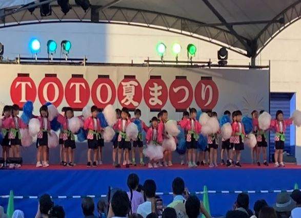 Scenes from the TOTO Group Summer Festival, children dancing on stage and the audience